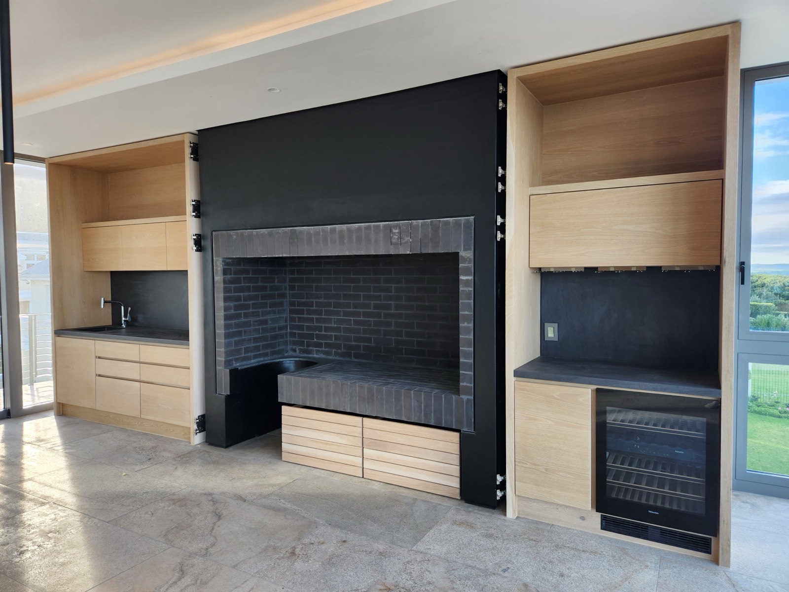 Built-in braai, dark stone surround on oak